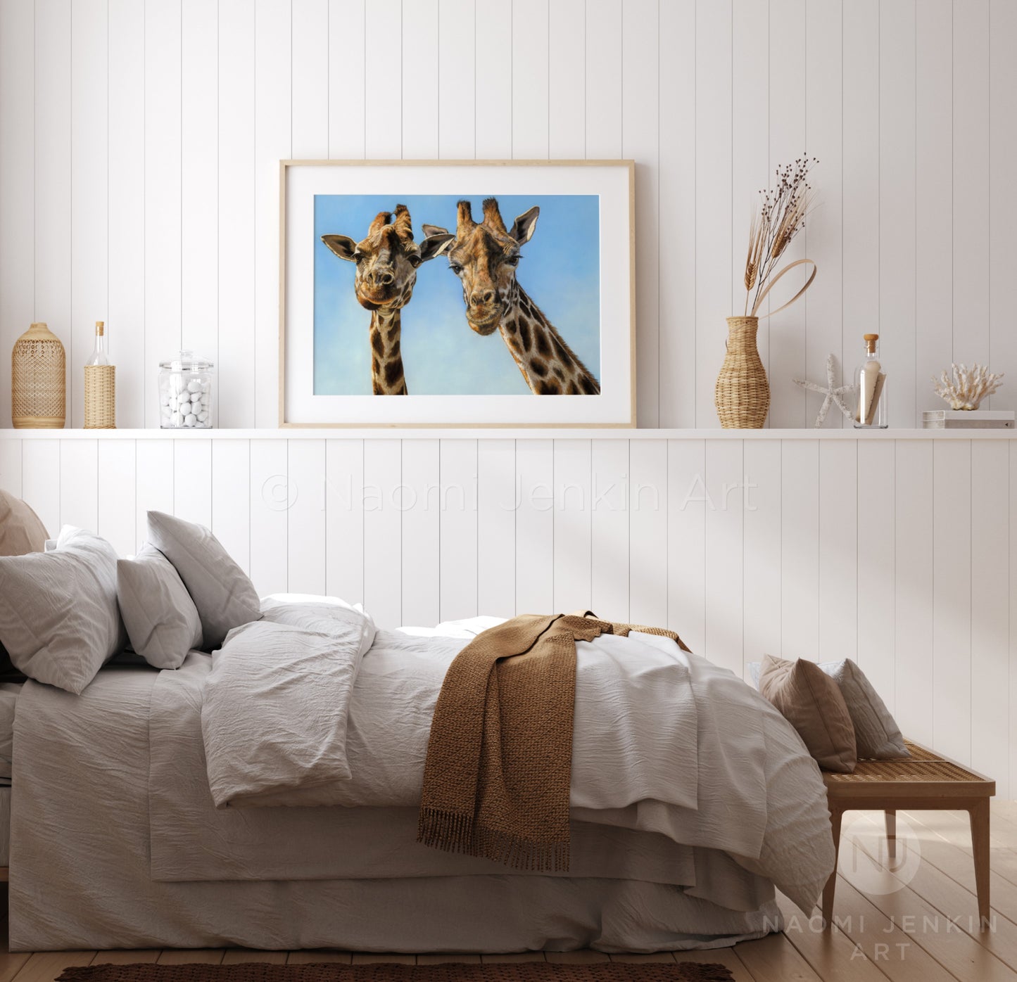 Framed giraffe art print in a bedroom setting by wildlife artist Naomi Jenkin