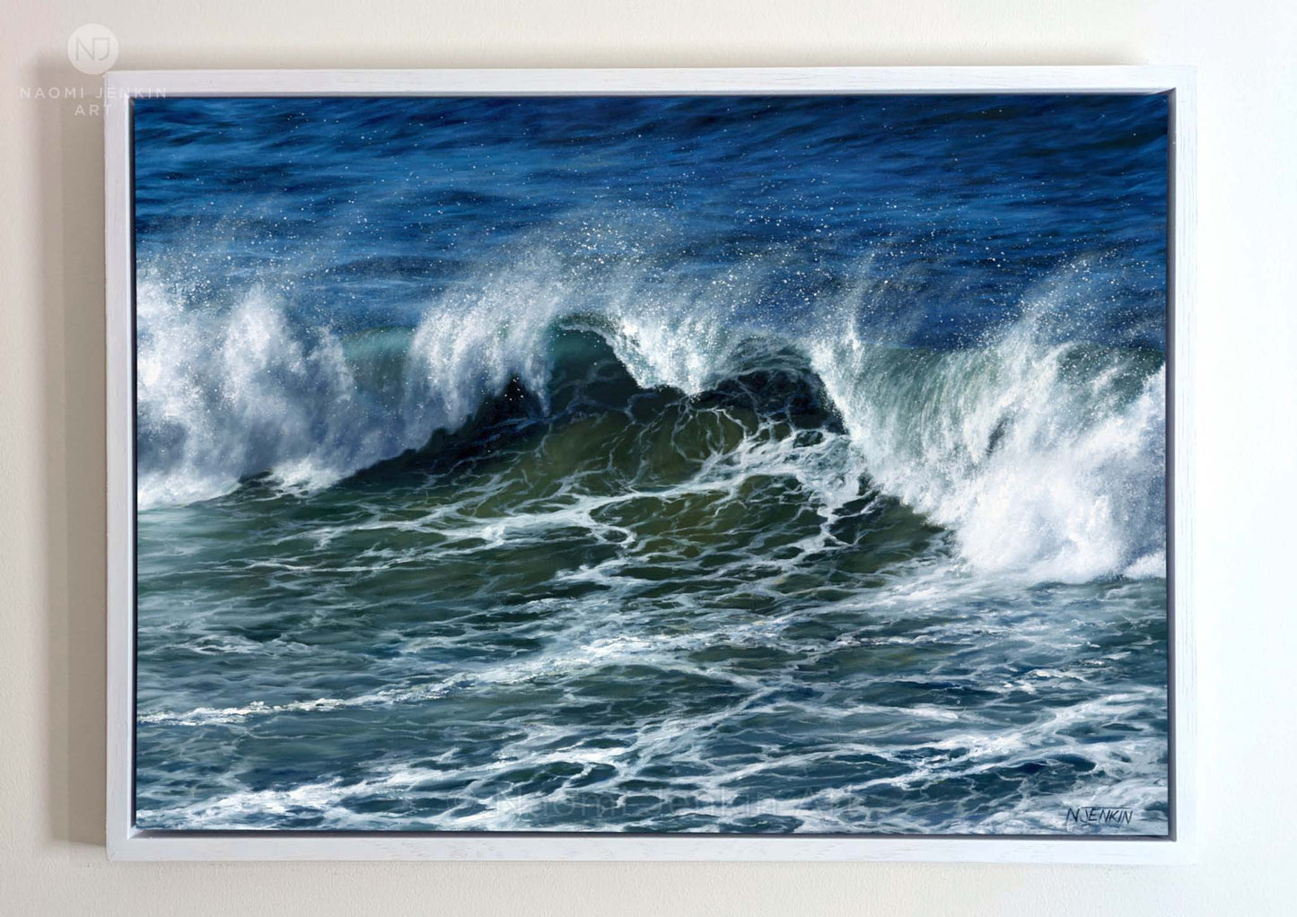 Framed original oil painting by Naomi Jenkin of a large breaking wave on a stormy North Cornish sea, with spray blown back by offshore winds, painted in deep blues and greens