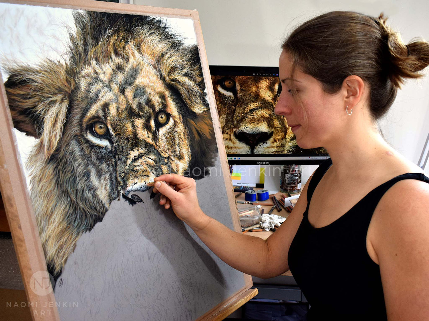 Wildlife artist Naomi Jenkin with original pastel lion painting "Warrior"