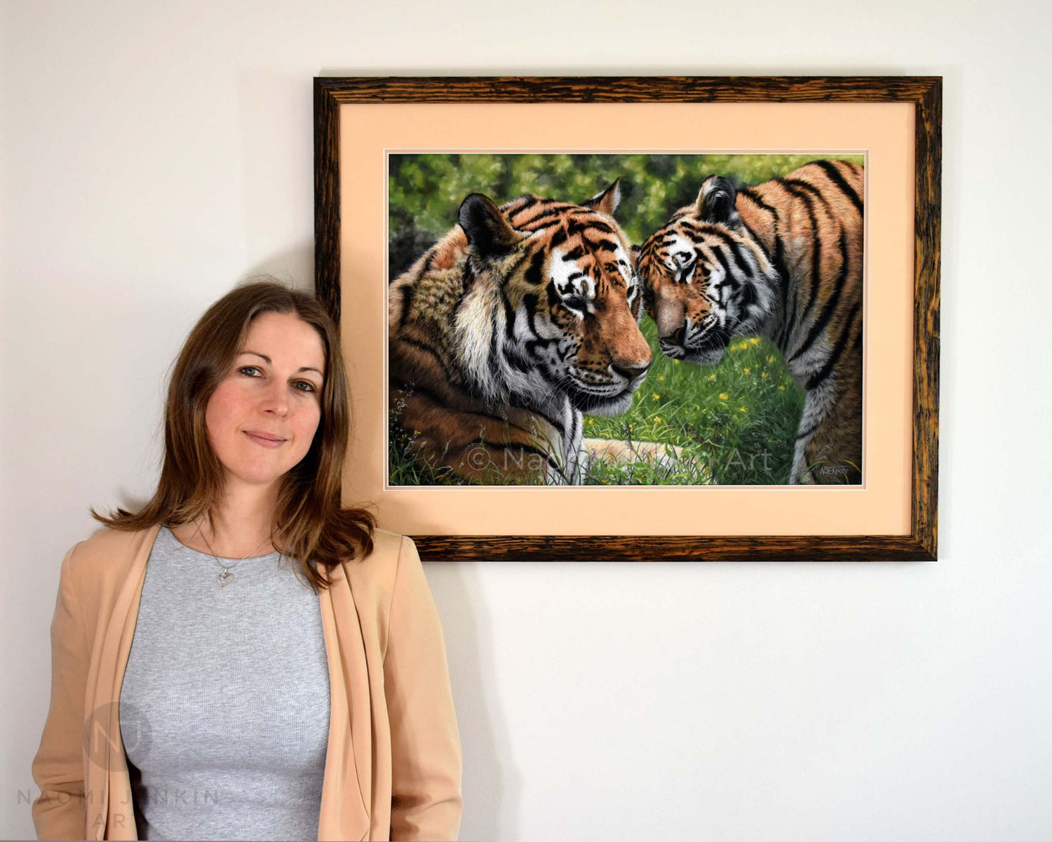 Wildlife artist Naomi Jenkin with her framed tiger painting "Allegiance".
