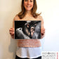 Wildlife artist Naomi Jenkin with her chimpanzee drawing "Embrace" in support of Explorers Against Extinction 'Sketch for Survival 2024'.
