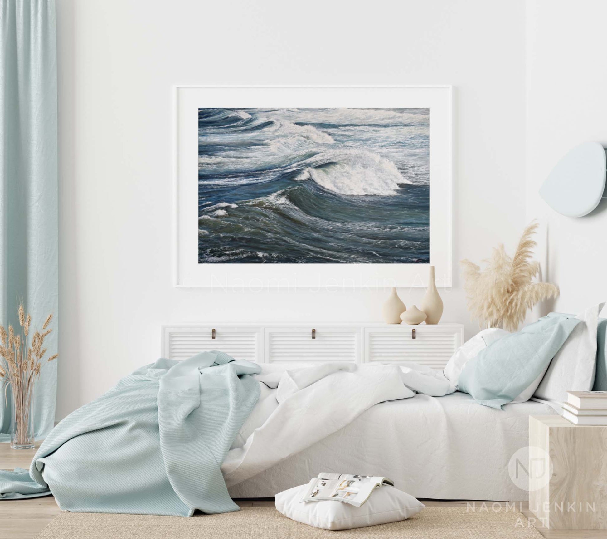 Framed wave print 'Wind Swept Rollers' by seascape artist Naomi Jenkin in a bedroom setting
