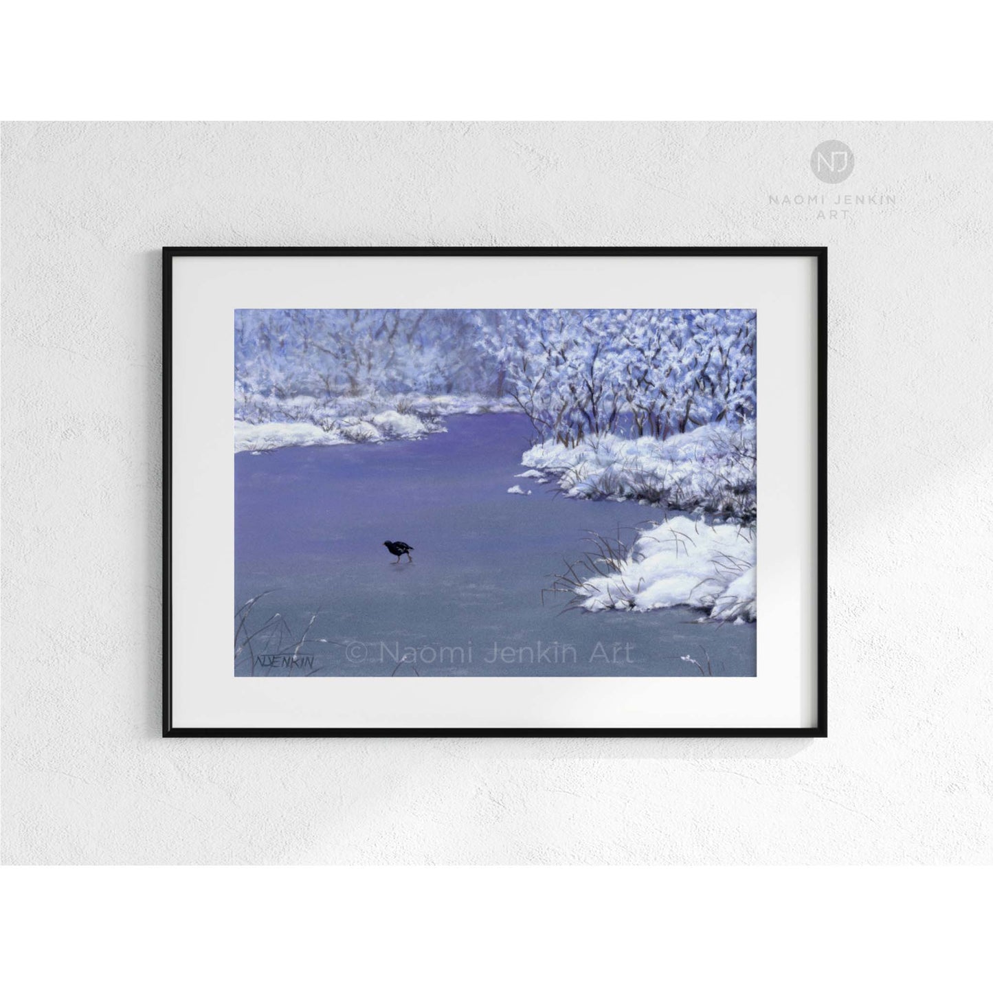 Framed artwork of a snowy landscape with a bird on a frozen lake. Drawn by artist Naomi Jenkin. 