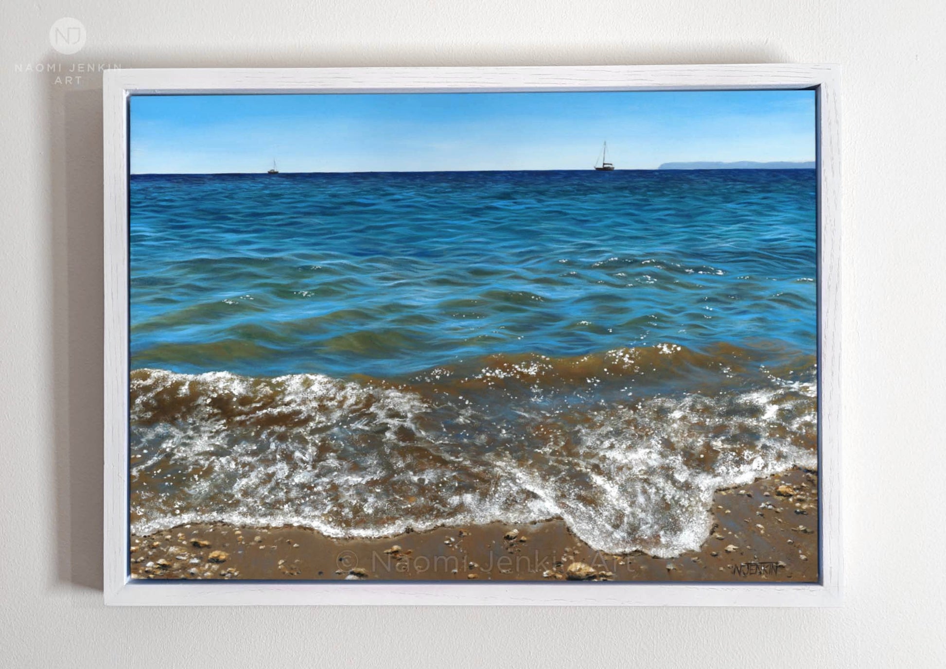 Framed original oil painting by Naomi Jenkin depicting the shoreline at Lantic Bay, Cornwall on a calm sunny day, with turquoise water, two small yachts on the horizon, and the distant outline of Gribbin Head.