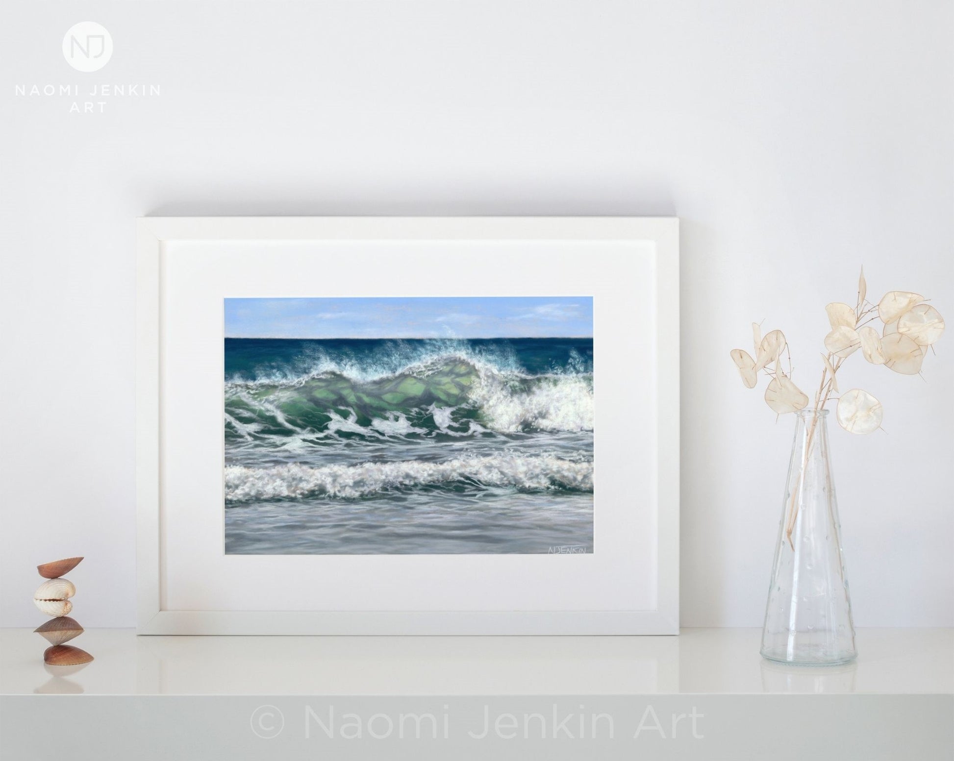 Original ocean painting "Sun Kissed Swell" by Naomi Jenkin displayed in a white frame. 
