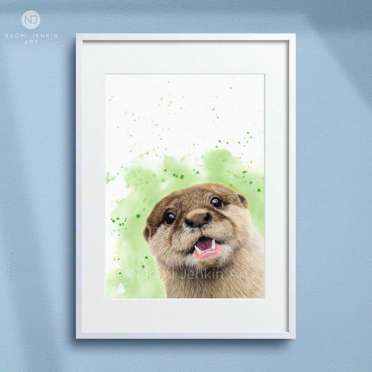 Framed artwork of an otter with a green watercolour background by artist Naomi Jenkin. 