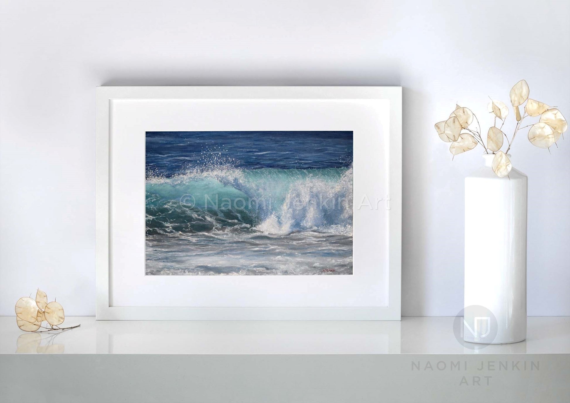 Framed wave art print 'Summer Beachbreak' by seascape artist Naomi Jenkin on a shelf setting